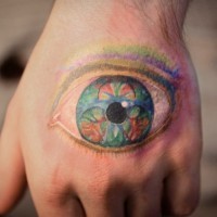 Nice multicolored detailed on hand tattoo of mystical eye