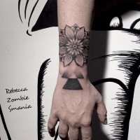Nice painted black and white flower with geometrical figure tattoo on wrist