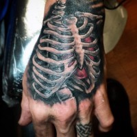Nice painted colored chest bones with heart tattoo on hand