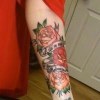 Nice roses and inscription forearm tattoo
