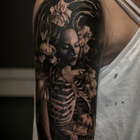 Nice skeleton woman in flowers tattoo on shoulder