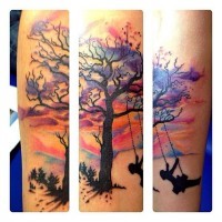 Nice watercolor tree and swing tattoo on arm