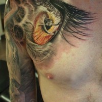 Nice woman in pupil eyes tattoo on shoulder