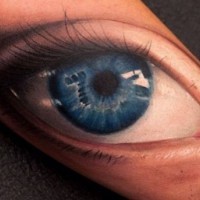 Number seven in blue human eye tattoo on arm