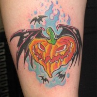 Old cartoon like bat shaped arm tattoo of flying pumpking