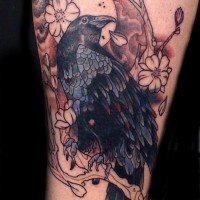 Old cartoon style colored bleeding crow with blooming tree tattoo on leg with lettering