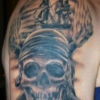 Old cartoon style painted shoulder tattoo of pirate skull with pirate ship