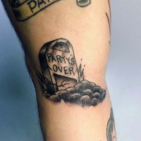 Old cracked gravestone with funny lettering tattoo
