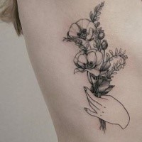 Old looking detailed side tattoo of hand holding flowers by Zihwa