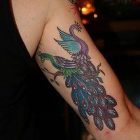 Old school arm tattoo with two purple peacocks