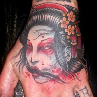 Old school Asian style little hand tattoo of geisha severed head