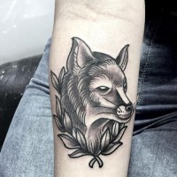 Old school black ink mystical fox tattoo on forearm with leaves