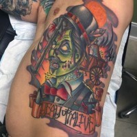 Old school cartoon like colored zombie tattoo on side with lettering