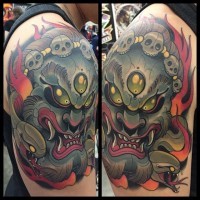Old school cartoon style colored evil monster on shoulder tattoo with snakes