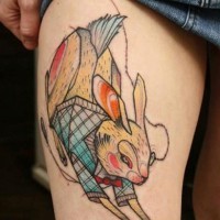 Old school cartoon style colored running rabbit tattoo on thigh