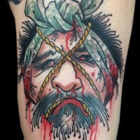 Old school colored arm tattoo of bloody Asian man severed head