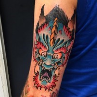 Tatuaje en el antebrazo, cara de dragón furioso multicolor, estilo old school