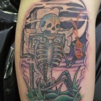 Tatuaje en el brazo, esqueleto triste con botella y lápida, estilo old school