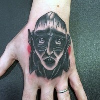 Old school colored funny Count Dracula's portrait tattoo on hand