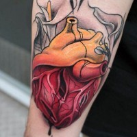 Old school colored human heart tattoo on forearm
