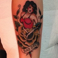 Old school colored little seductive woman tattoo on forearm combined with rose flower and lettering