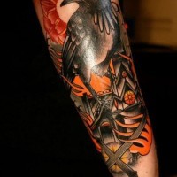 Old school colorful forearm tattoo of crow with burning city