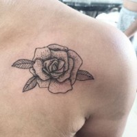Old school detailed rose flower tattoo on shoulder with small dots