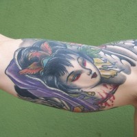 Old school multicolored bloody Geisha head tattoo on biceps