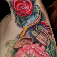 Old school multicolored shoulder and neck tattoo of various flowers and mirror