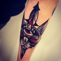 Old school mystical demonic cat tattoo on forearm with old dagger