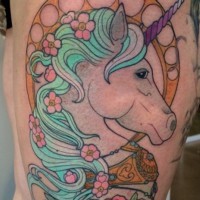 Old school natural colored thigh tattoo of fantasy unicorn and flowers