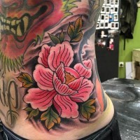 Old school pink colored flower tattoo on side