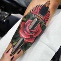 Old school simple designed forearm tattoo of red rose with dagger