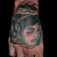 Old school simple painted hand tattoo of woman head with leaves and letteirng