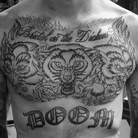 Old school style black and white chest and belly tattoo of Cerberus with lettering and flames