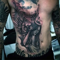 Tatuaje de mujer ángel triste en el pecho y estómago