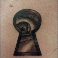 Old school style black ink tattoo of creepy eye with keyhole
