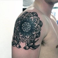 Old school style black ink upper arm tattoo of big flower with birds
