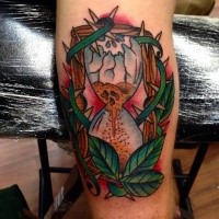 Old school style colored arm tattoo of broken sand clock with vine and leaves