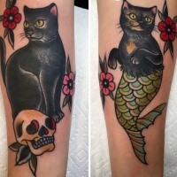Old school style colored arm tattoo of half cat half mermaid with skull and flowers
