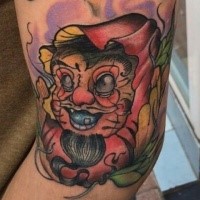 Old school style colored arm tattoo of funny daruma doll with leaves