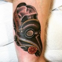Old school style colored arm tattoo of human skull with plague doctors mask and flowers