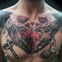 Old school style colored chest tattoo of human hands with flower, lettering and cross