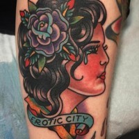 Old school style colored crying woman tattoo on arm with lettering