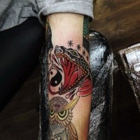 Old school style colored evil snake with owl tattoo on forearm