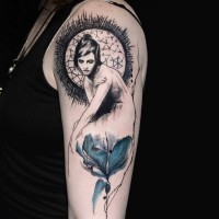 Old school style colored flower tattoo on shoulder combined with woman portrait