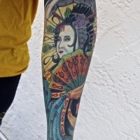 Old school style colored forearm tattoo of geisha woman with fan