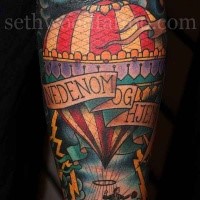 Old school style colored forearm tattoo of man with balloon and lettering