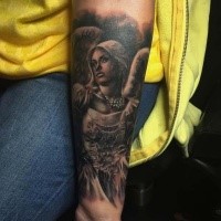 Old school style colored forearm tattoo of angel woman