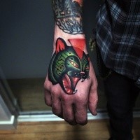 Old school style colored hand tattoo of roaring cat and red triangle